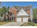 Traditional brick home with a two-car garage and well-maintained front yard at 3647 Bancroft Main Nw, Kennesaw, GA 30144
