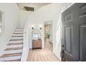 Bright foyer with hardwood floors, staircase, and modern decor at 3647 Bancroft Main Nw, Kennesaw, GA 30144
