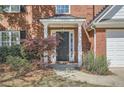 Welcoming front entrance with a black door, white columns, and lush landscaping at 3647 Bancroft Main Nw, Kennesaw, GA 30144