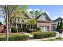 Beautiful brick home with a three car garage, mature landscaping, and manicured lawn at 4620 Westgate Dr, Cumming, GA 30040