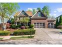 Beautiful brick home with a three-car garage and well-manicured landscaping at 4620 Westgate Dr, Cumming, GA 30040