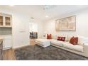 Bright living room boasts a large sectional sofa, modern art, and a ceiling fan at 1101 Collier Nw Rd # U2, Atlanta, GA 30318