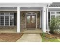 Inviting entryway with a wood double door, flanked by windows and classic brickwork at 1350 Blackwell Rd, Marietta, GA 30066