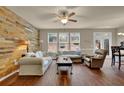 Inviting living room with hardwood floors, a wood accent wall, and lots of natural light at 587 Jody Pl, Lilburn, GA 30047