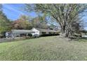 Ranch-style house on a spacious lot with a covered carport and mature trees at 3081 Frankie Ln, Duluth, GA 30096