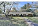 Charming single-story home features a well-manicured lawn and a neatly paved walkway to the front door at 3081 Frankie Ln, Duluth, GA 30096