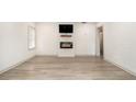 Bright living room features modern flooring, a fireplace with a TV, and fresh, white walls at 609 Spring St, Atlanta, GA 30354