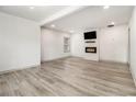 Bright, empty living room features modern flooring, a fireplace with a TV, and fresh, white walls at 609 Spring St, Atlanta, GA 30354
