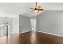 Spacious bonus room with hardwood floors, modern ceiling fan, and natural lighting at 6332 Fairoaks Pl, Douglasville, GA 30135