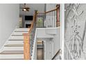 Inviting foyer with white trim, wood railing, and stylish wrought iron spindles at 6332 Fairoaks Pl, Douglasville, GA 30135