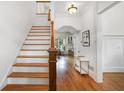 Inviting entryway with hardwood floors, staircase, and view to the kitchen at 1257 Arkwright Se Pl, Atlanta, GA 30317