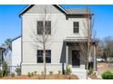 Beautiful two-story home with gray siding and brick foundation and a welcoming covered front porch at 3322 Springhaven Ave, Hapeville, GA 30354