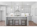 Modern kitchen with stylish gray cabinets, stainless steel appliances, quartz countertops, and an island with seating at 3322 Springhaven Ave, Hapeville, GA 30354
