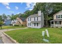 Exterior shot of a two-story home showcasing a front lawn in need of some TLC on a sunny day at 425 Orchard Dr, Stone Mountain, GA 30083