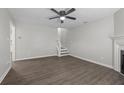 Spacious living room featuring hardwood floors, a ceiling fan, and access to the staircase at 425 Orchard Dr, Stone Mountain, GA 30083