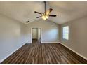 Spacious living room with vaulted ceilings, modern ceiling fan, and stylish wood-look floors for a modern feel at 118 Dove Lndg, Social Circle, GA 30025