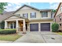 Inviting two-story home with a covered front porch and a two-car garage at 13030 Dartmore Ave, Alpharetta, GA 30005
