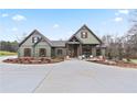 New construction home with light green siding, dark timbers, beautiful landscaping, and concrete driveway at 510 Price Rd, Carrollton, GA 30116