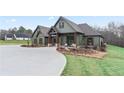 New construction with light green siding, dark timbers, concrete driveway, and mature landscaping at 510 Price Rd, Carrollton, GA 30116