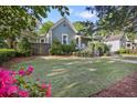 Well-maintained front yard, showcasing a charming home with blossoming flowers and mature trees, creating a serene setting at 176 Stewart Nw Ave, Marietta, GA 30064
