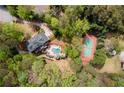 Beautiful home with a pool and a tennis court set among lush green surroundings at 1886 Chedworth Ct, Stone Mountain, GA 30087
