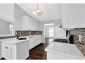 Modern kitchen boasting white cabinetry, quartz countertops, stylish tile backsplash, and gas range at 2865 Maple Vista Ln, Lawrenceville, GA 30044