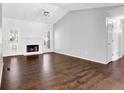 Spacious living room with hardwood floors, a cozy fireplace, and large windows for natural light at 2865 Maple Vista Ln, Lawrenceville, GA 30044