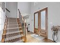 The front entrance features hardwood floors and staircase leading to the upper level at 11570 Dunhill Place Dr, Johns Creek, GA 30005