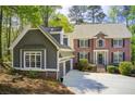 Lovely two-story house featuring a brick facade and a well-manicured front yard surrounded by lush greenery at 201 Rippling Nw Dr, Marietta, GA 30064