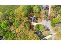 Aerial view of a wooded property with home, driveway, and surrounding greenery at 530 S Lost Lake Cv, Villa Rica, GA 30180