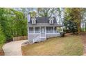 Charming home with a welcoming front porch and well-maintained lawn and driveway at 530 S Lost Lake Cv, Villa Rica, GA 30180
