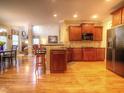 Open kitchen with wood cabinets, granite countertops, and hardwood flooring at 5610 Hollowbrooke Ln, Acworth, GA 30101