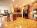 Spacious kitchen with wood cabinets, stainless steel refrigerator and hardwood floors at 5610 Hollowbrooke Ln, Acworth, GA 30101