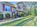 Beautiful home with a well-maintained lawn, colorful flowerbeds, and a welcoming front entrance at 6040 Carriage Dr, Cumming, GA 30028