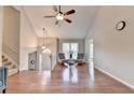 Spacious living room with gleaming hardwood floors, high ceilings, and an abundance of natural light at 6040 Carriage Dr, Cumming, GA 30028