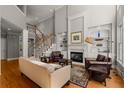 Bright living room with hardwood floors, fireplace, and built-in shelving at 12120 Dancliff Trce, Alpharetta, GA 30009