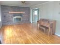 Inviting living room features a brick fireplace and gleaming hardwood floors at 1256 E Piedmont Rd, Marietta, GA 30062