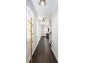 Bright hallway featuring hard wood floors and modern lighting fixtures at 3717 Silvery Way, Powder Springs, GA 30127