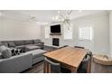 Comfortable living space with a fireplace, a ceiling fan, and a gray sectional couch at 3717 Silvery Way, Powder Springs, GA 30127
