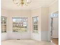 Cozy dining room featuring neutral carpet, bay windows, and a classic chandelier at 6028 Connaught Se Dr, Mableton, GA 30126