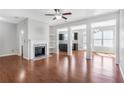 Spacious living room with hardwood floors, fireplace, open floor plan, and large windows at 6625 Story Cir, Norcross, GA 30093