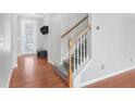 Carpeted staircase features wooden handrails, leading to the upper level of the home at 6625 Story Cir, Norcross, GA 30093