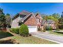 Charming home with brick and siding accents, a two-car garage, and a well-manicured front lawn at 1630 Chadwick Mill Ln, Lawrenceville, GA 30043