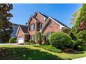 A beautiful brick home with lush greenery, offering a welcoming and picturesque view at 1630 Chadwick Mill Ln, Lawrenceville, GA 30043