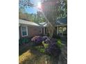Inviting front yard with brick facade, mature landscaping, and manicured flowerbeds at 1910 Cooper Landing Se Dr, Smyrna, GA 30080