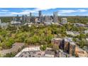 Stunning aerial view of lush greenery with city skyline in background, showing location and upscale community at 3235 Roswell Ne Rd # 508, Atlanta, GA 30305