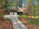 Charming two-story home with a brick chimney, attached garage, and long driveway at 758 Lauren Cir, Lawrenceville, GA 30043
