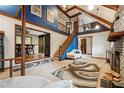 Open living room features a grand staircase, exposed beams, fireplace, and access to other rooms at 758 Lauren Cir, Lawrenceville, GA 30043