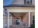 Inviting front porch with brick flooring and comfortable seating at 314 Lakeside Trce, Canton, GA 30115
