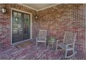Covered front porch with rocking chairs and stylish brick flooring at 314 Lakeside Trce, Canton, GA 30115